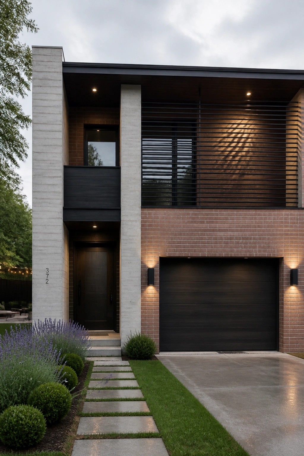 Modern two-story house facade with concrete pillars, brick walls, dark wood slats on the upper level, black garage door, and a small balcony above the entry.
