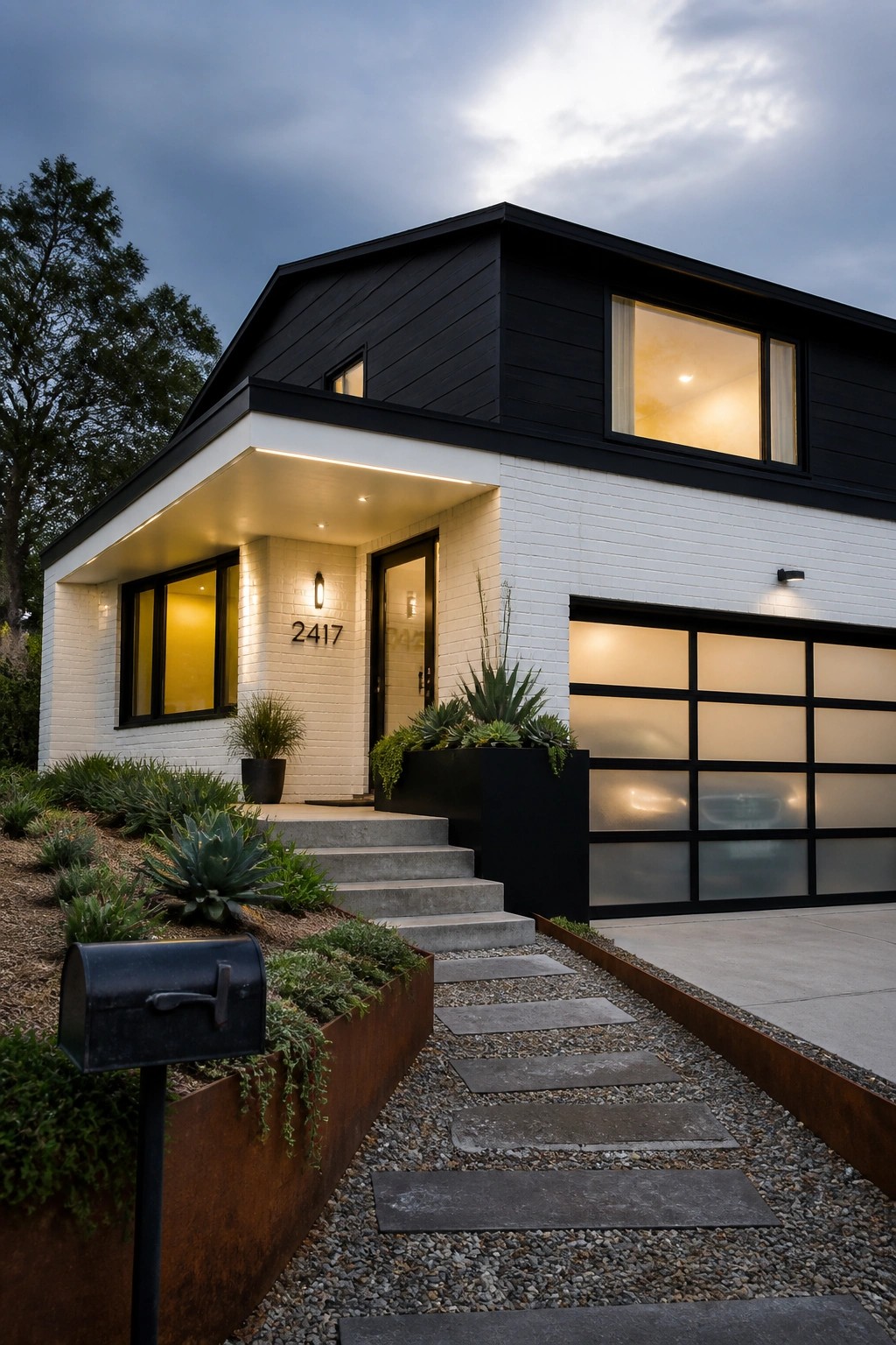 A modern two-story house exterior with black siding on the upper level and white brick on the lower level, showing a front entry with steps and an attached garage.