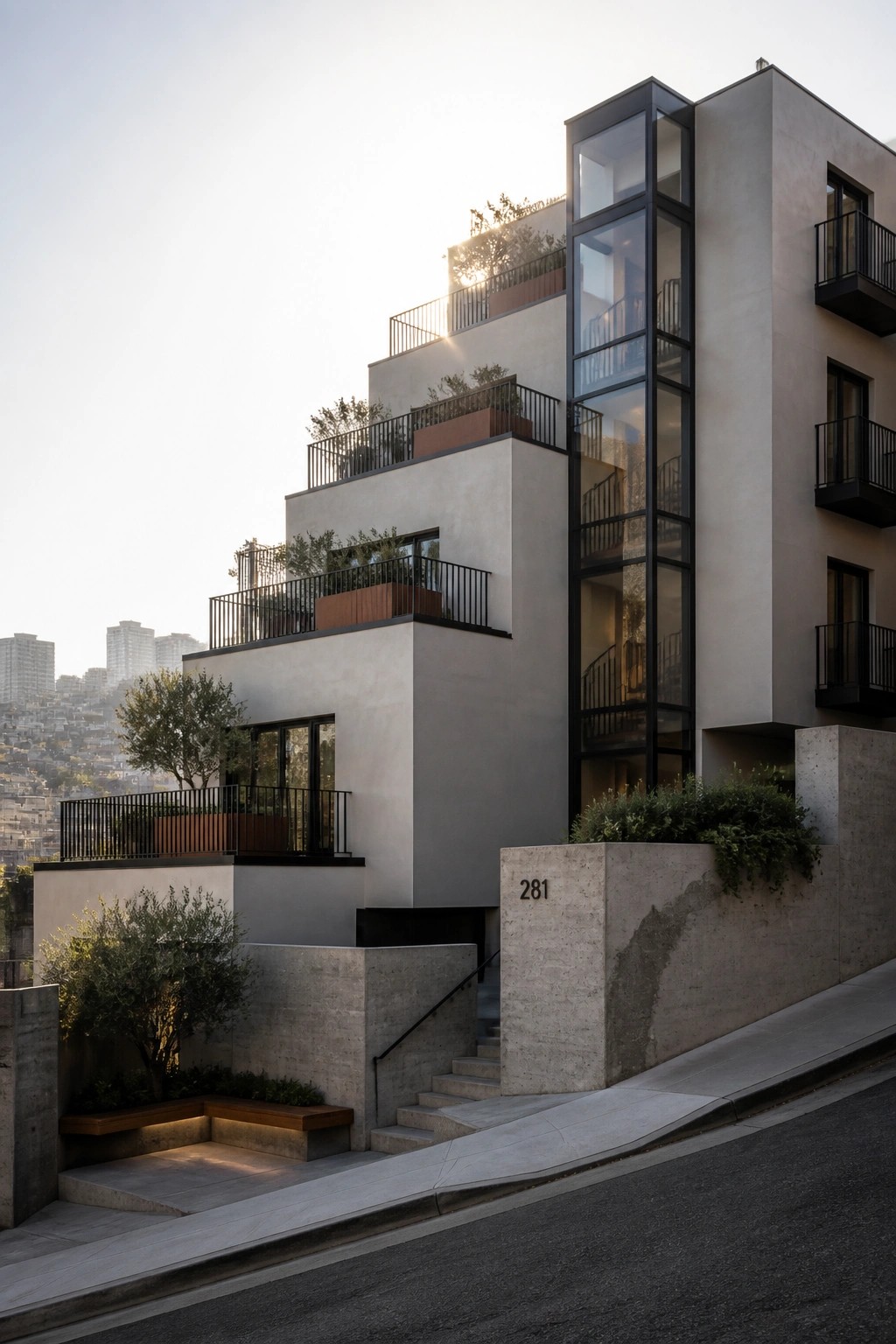 A modern multi-story apartment building with stepped concrete terraces, black railings, integrated planters, and a prominent glass elevator shaft on the right side.