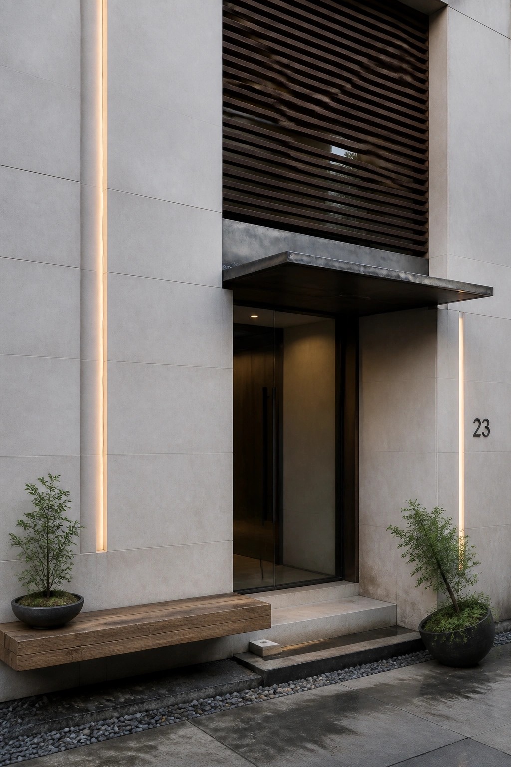 Modern house entrance featuring light gray stone walls with two vertical glowing light strips, a floating wooden bench with a potted plant on the left, another potted plant on the right, dark horizontal wood slats above, and a glass door under a metal overhang.