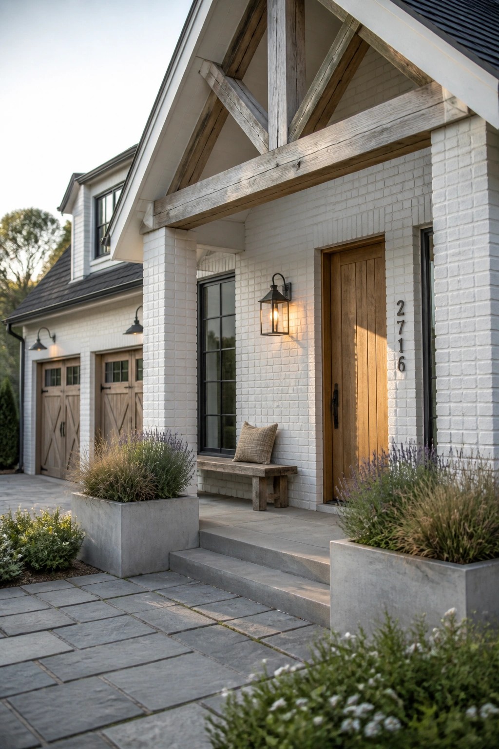 A white brick house with exposed timber beams over the porch, a wooden front door, and concrete planters along the steps.